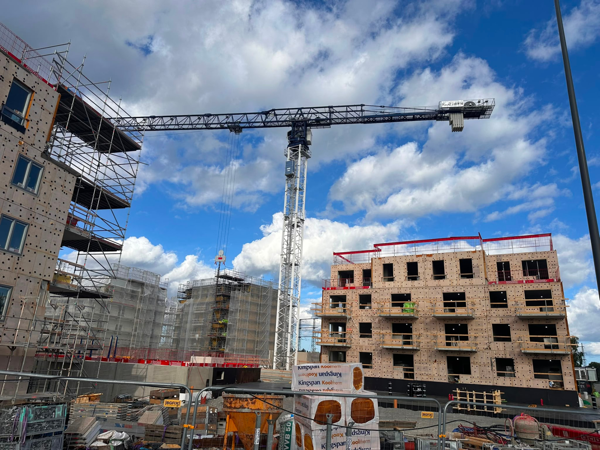 Active construction site with tower crane and buildings under construction